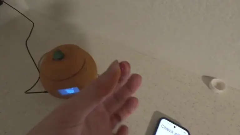 Peel device demonstration showing its cap opening and the illuminated sample chamber