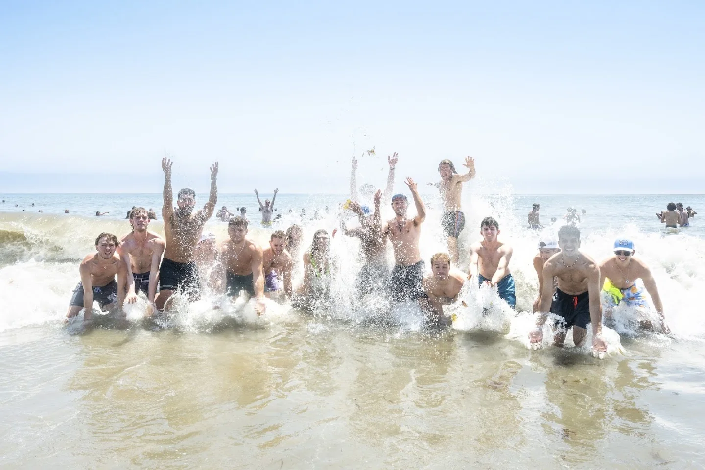 Plunge participants celebrating together in the ocean on June 1, 2025